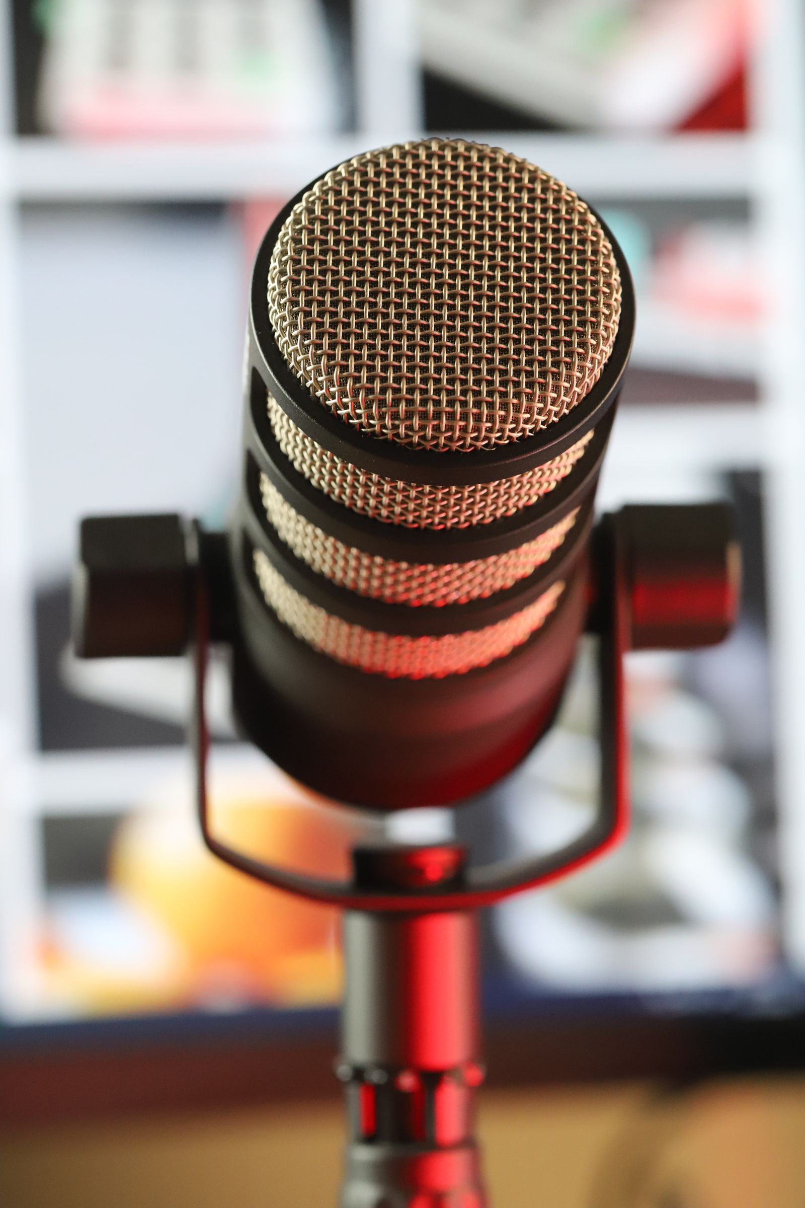 Host recording an episode of a community podcast in a small studio